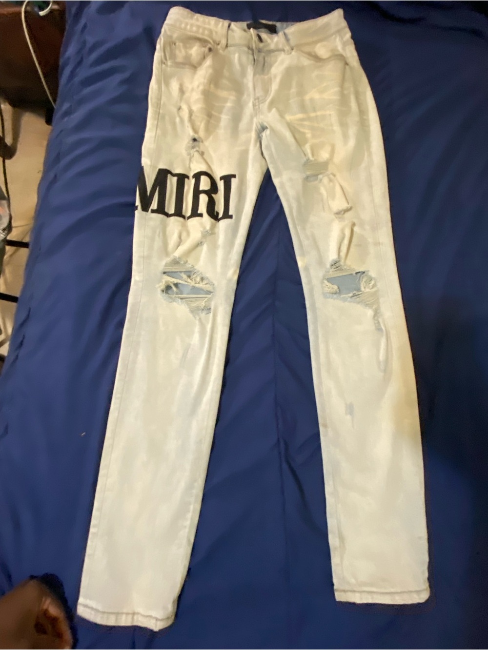 AMIRI Light Blue Distressed Skinny Jeans with Black Logo